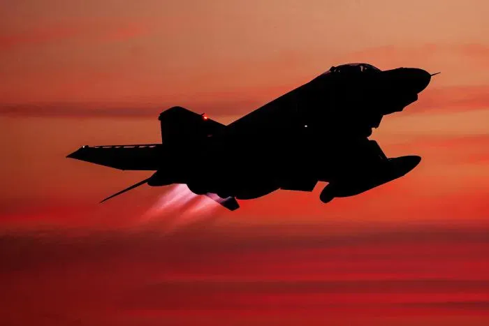 F-4 Phantom II fighter jet in flight at dusk, representing the Imperial Iranian Air Force intercept of September 1976